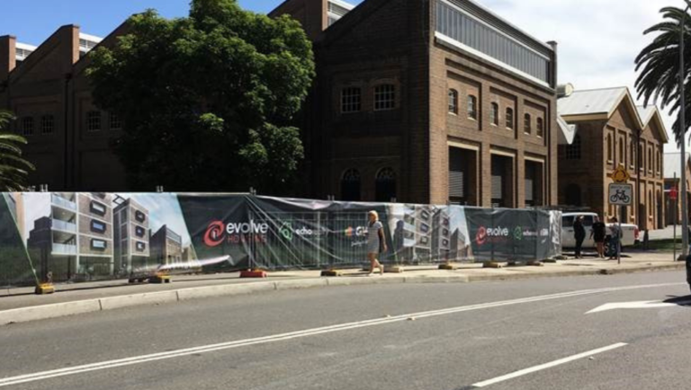 An image showing fencing up around the site at 4 Merewether Street, Newcastle that will be developed into new affordable housing