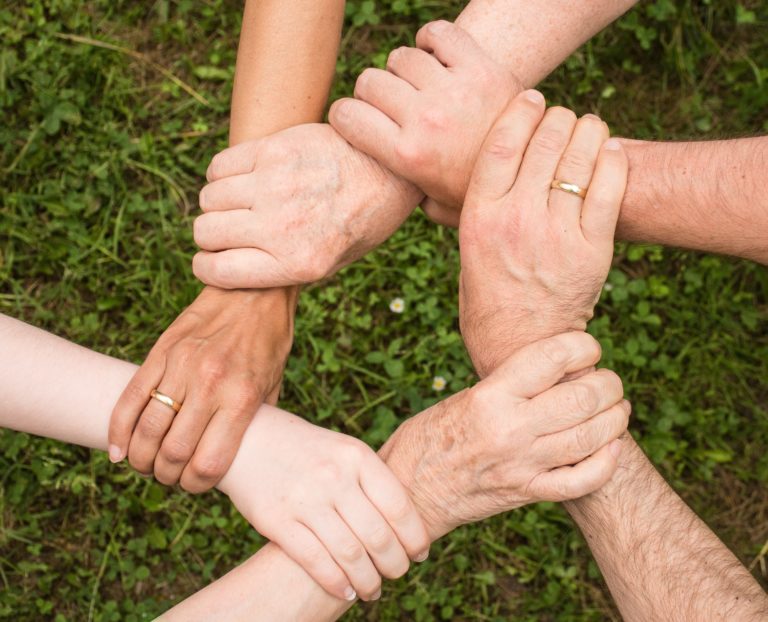 People with their hands together working as a team